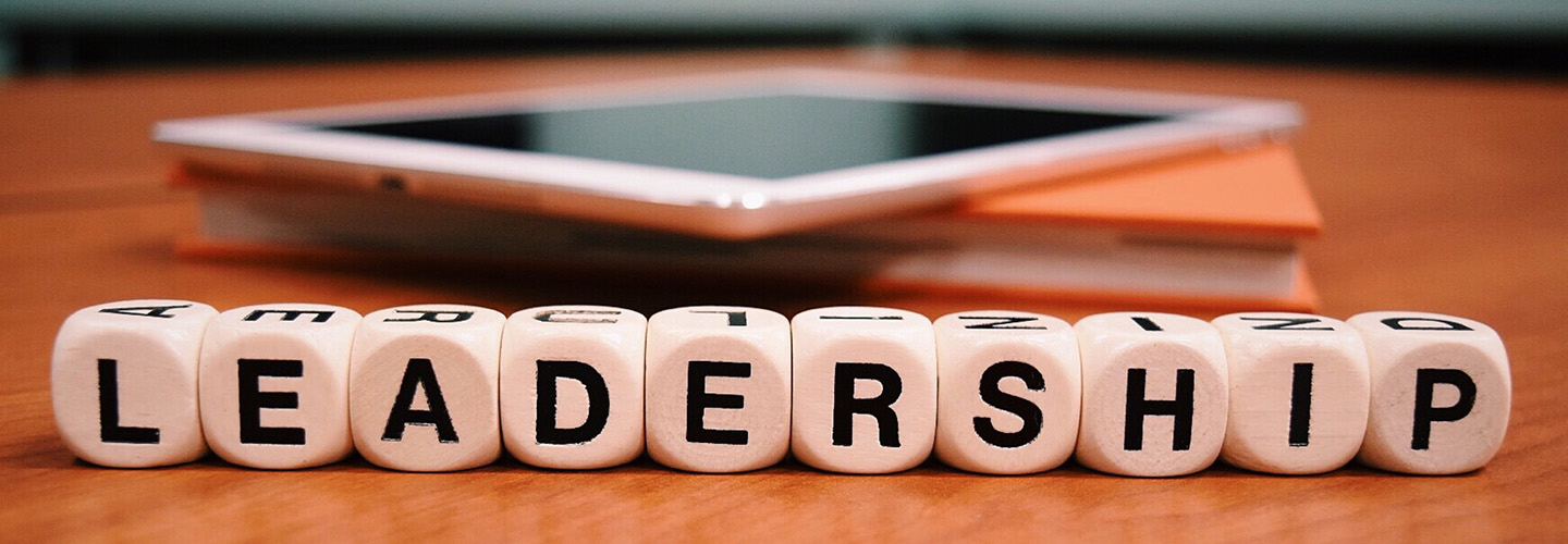 The word Leadership spelled out with cubic beads on a wooden desk